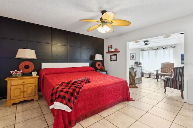 tiled bedroom featuring ceiling fan and a textured ceiling