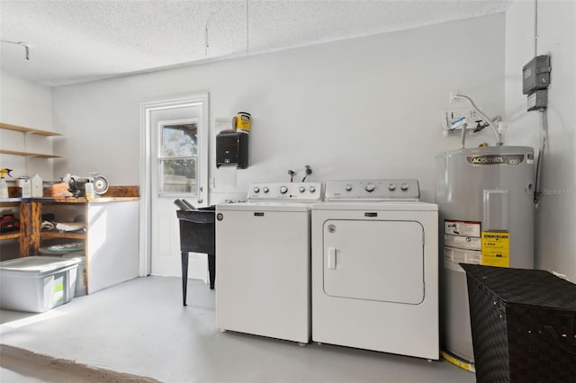 washroom with washer and clothes dryer, electric water heater, and a textured ceiling