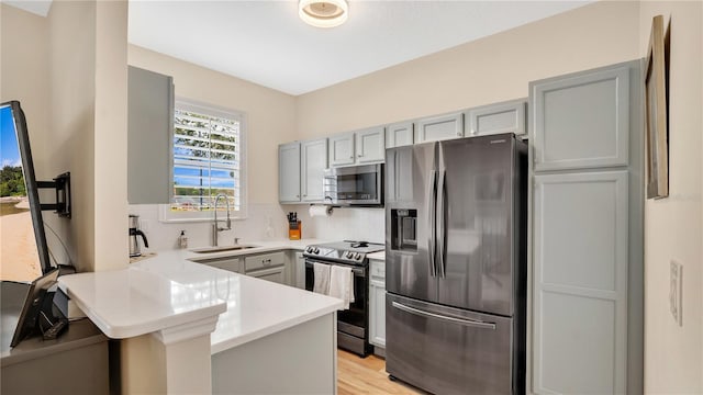 221 Aston Grande Dr, Daytona Beach, FL 32124 - kitchen featuring sink, backsplash, kitchen peninsula, and appliances with stainless steel finishes