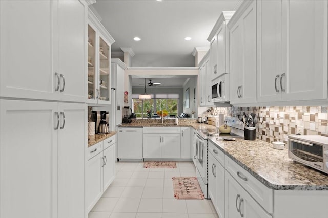 kitchen featuring backsplash, white cabinets, light tile patterned floors, light stone countertops, and white appliances