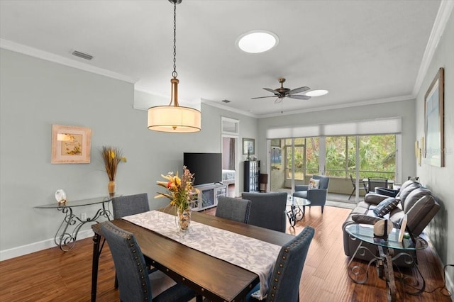 dining space featuring crown molding, ceiling fan, and hardwood / wood-style floors