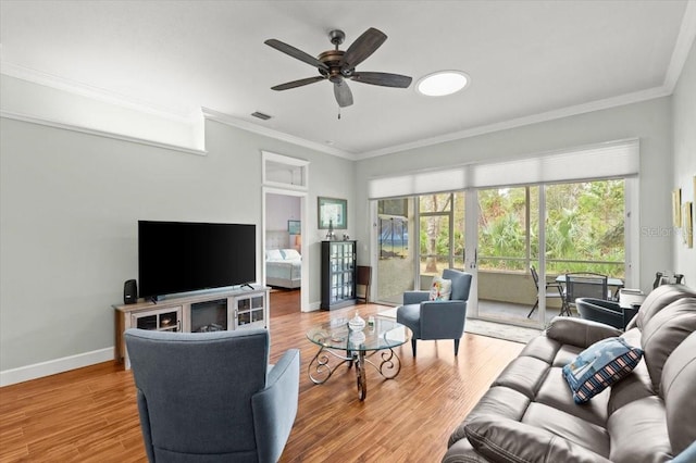 living room with hardwood / wood-style flooring, ornamental molding, and ceiling fan