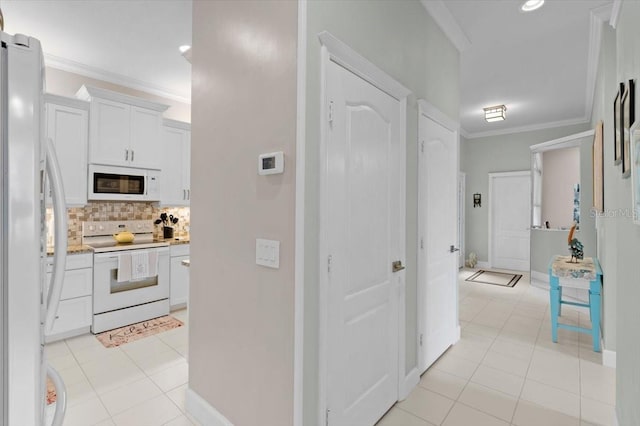 hallway with light tile patterned floors and crown molding