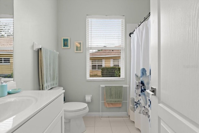 bathroom with tile patterned flooring, vanity, and toilet