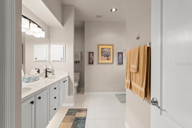 bathroom featuring tile patterned flooring, vanity, and toilet