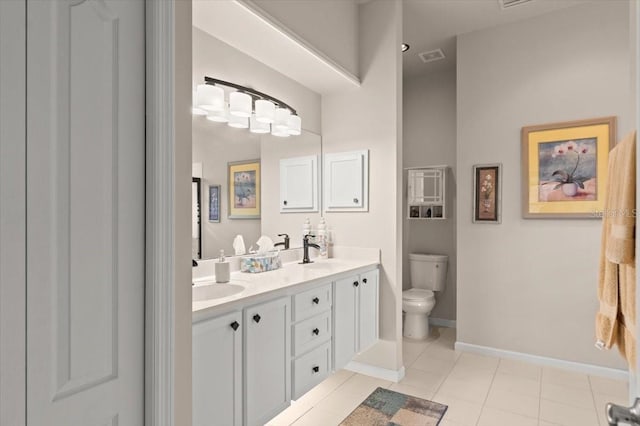 bathroom featuring vanity, tile patterned floors, and toilet