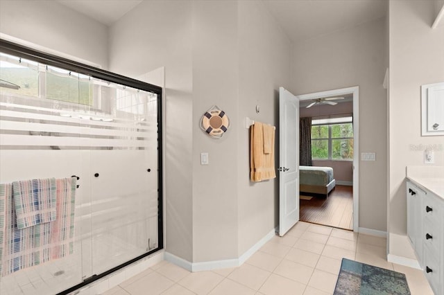 bathroom with tile patterned flooring, vanity, and an enclosed shower