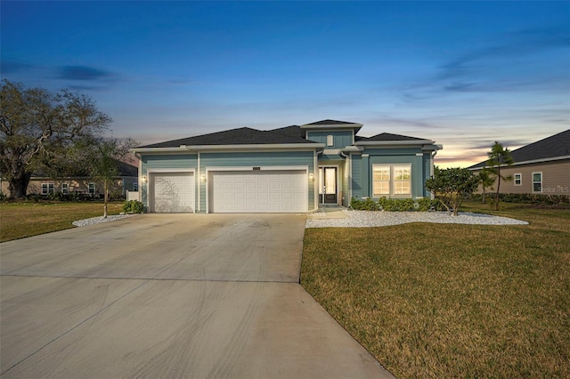 view of front facade featuring a garage and a lawn