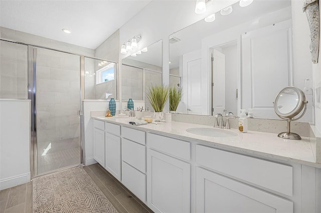 bathroom featuring vanity and a shower with shower door