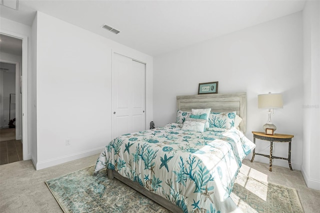 bedroom with light colored carpet and a closet