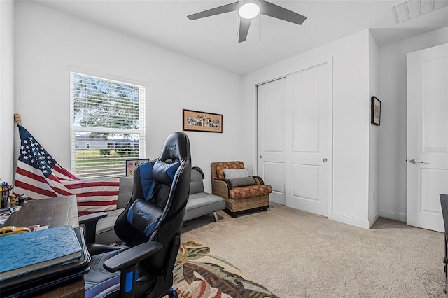 carpeted home office with ceiling fan