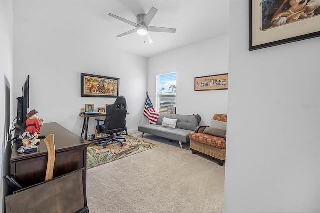 carpeted office space featuring ceiling fan