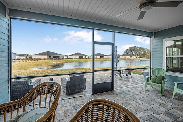 sunroom featuring a water view, ceiling fan, and wooden ceiling