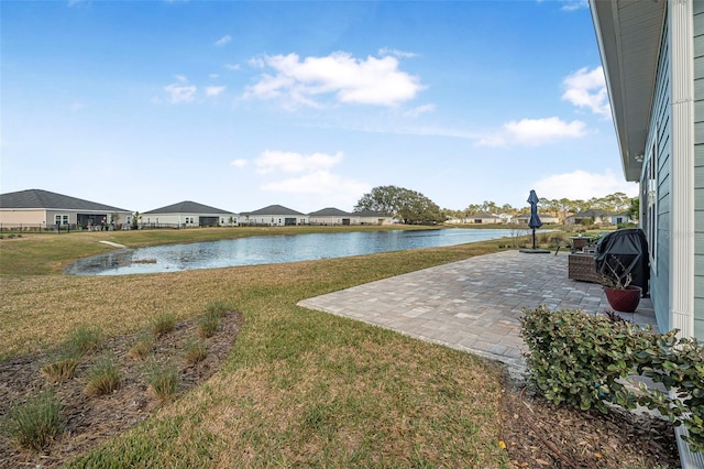 view of yard featuring a patio and a water view