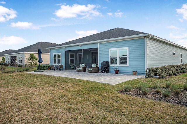 rear view of property with an outdoor living space, a yard, and a patio