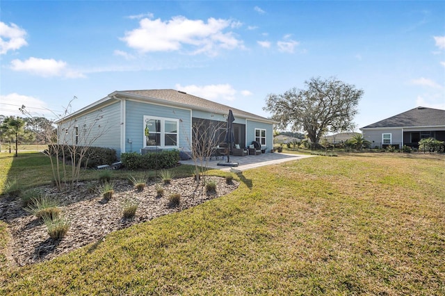 rear view of property with a patio and a yard