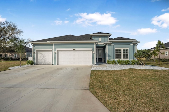 view of front of home with a garage and a front yard