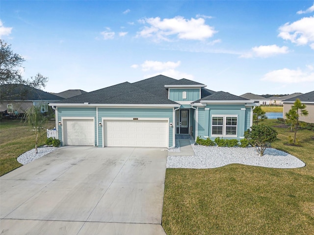 view of front of property with a garage and a front yard