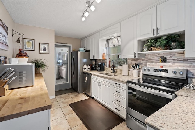 kitchen with white cabinetry, sink, and stainless steel appliances