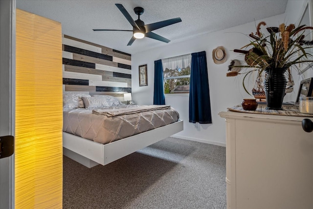 bedroom featuring ceiling fan, carpet floors, a textured ceiling, and wood walls