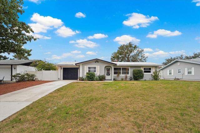 ranch-style house featuring a garage and a front lawn