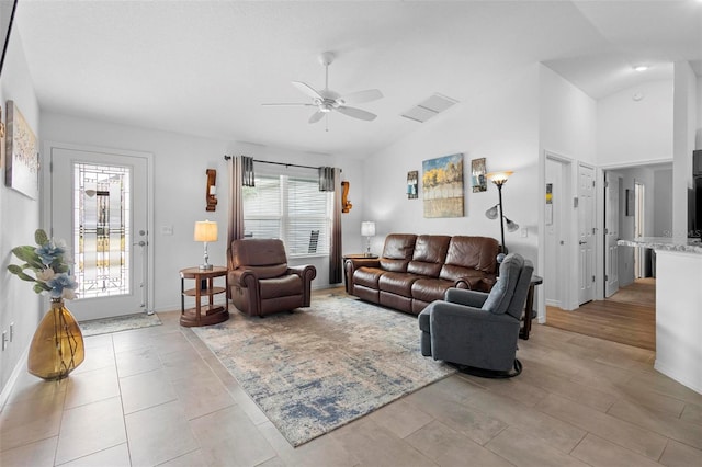 living room with high vaulted ceiling and ceiling fan