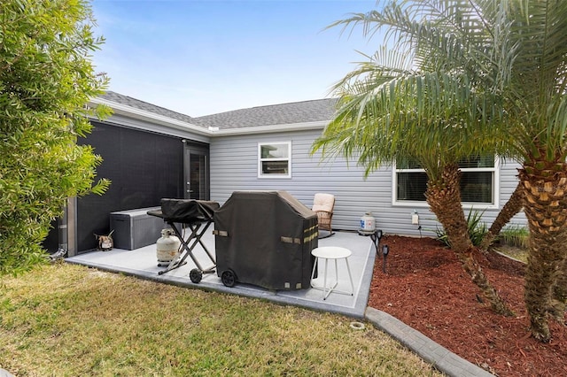 back of house with a yard and a patio