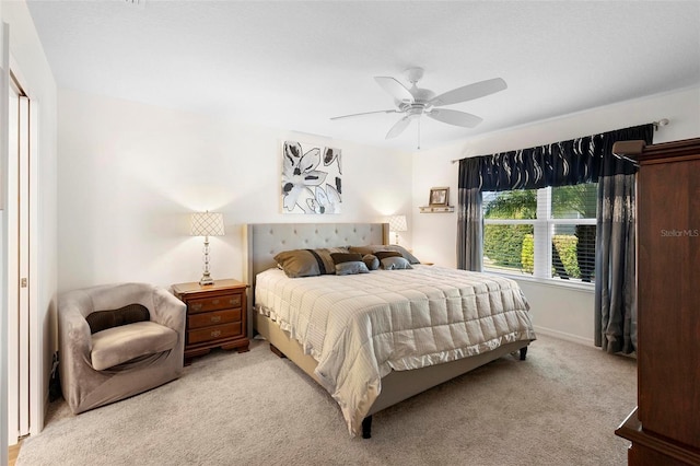 bedroom featuring light carpet and ceiling fan