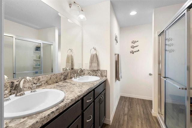 bathroom featuring vanity, an enclosed shower, and hardwood / wood-style floors