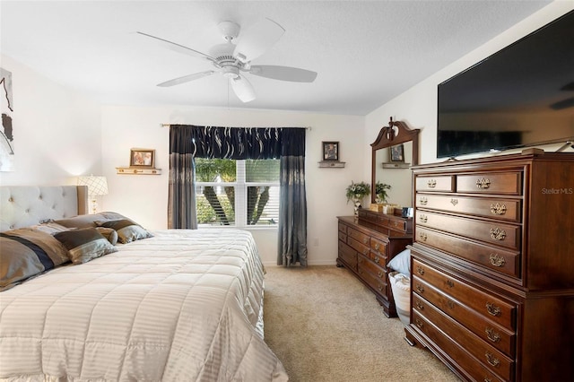 bedroom with ceiling fan and light carpet