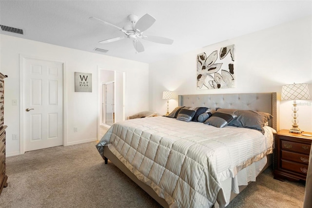 carpeted bedroom with ceiling fan and ensuite bathroom