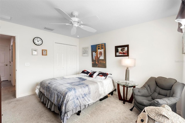 bedroom featuring light carpet, a closet, and ceiling fan