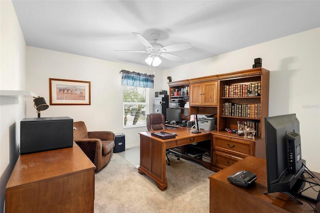 carpeted office space with ceiling fan