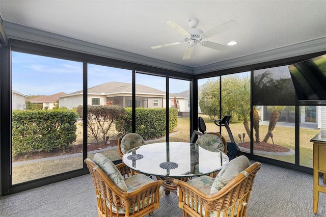 sunroom / solarium featuring ceiling fan