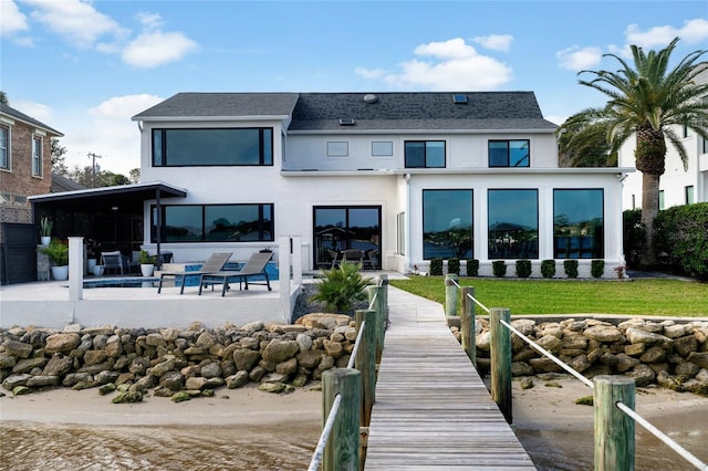 back of house with a fenced in pool and a patio