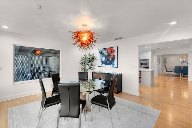 dining area with light hardwood / wood-style flooring