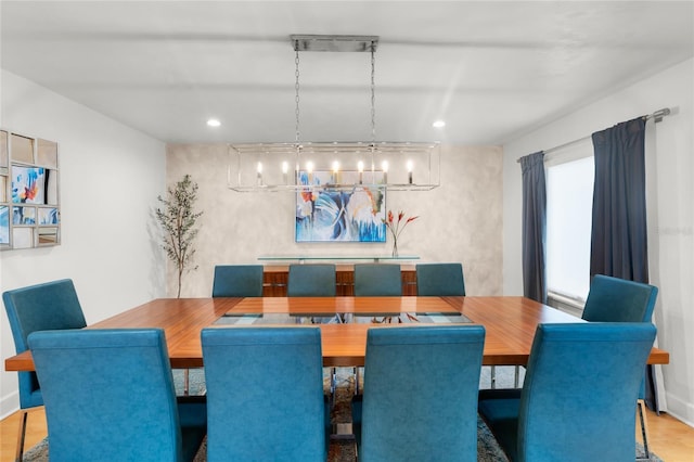 dining area featuring an inviting chandelier and hardwood / wood-style flooring