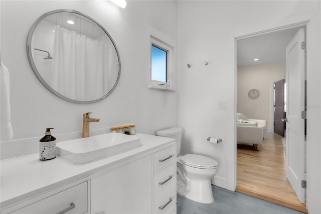 bathroom featuring vanity, toilet, and a shower with shower curtain