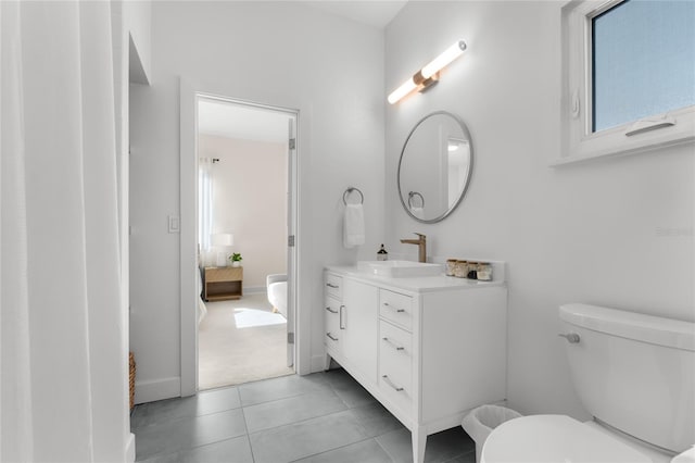 bathroom featuring vanity, tile patterned floors, and toilet