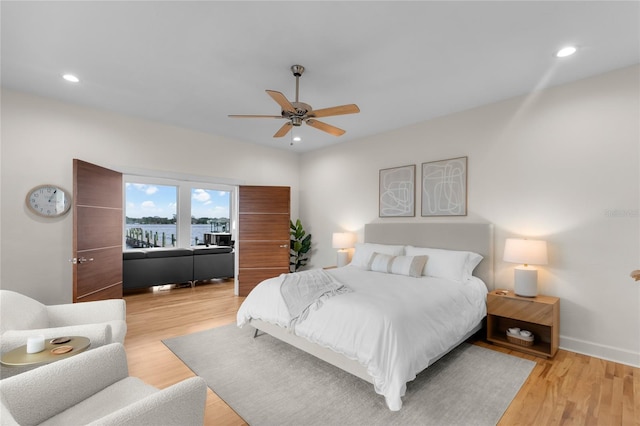 bedroom with ceiling fan and light hardwood / wood-style flooring