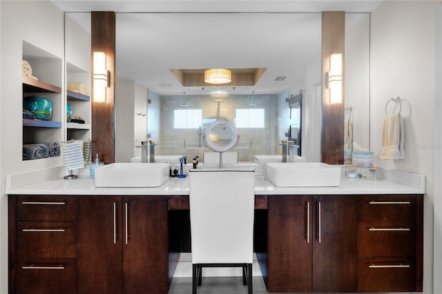 bathroom with vanity and a tray ceiling