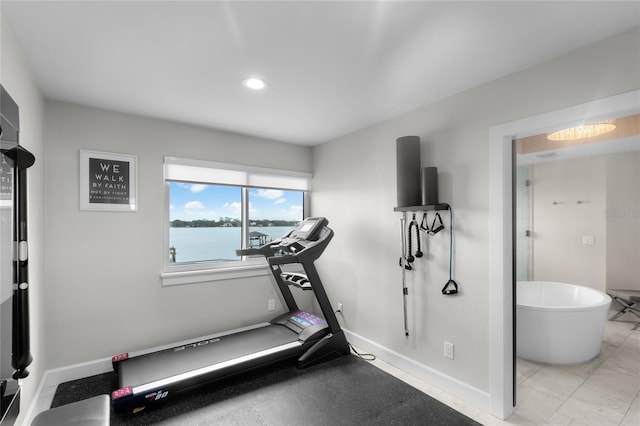 workout area featuring a water view