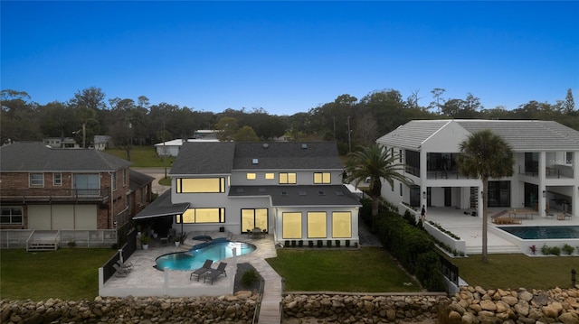 back of house featuring a patio area and a lawn