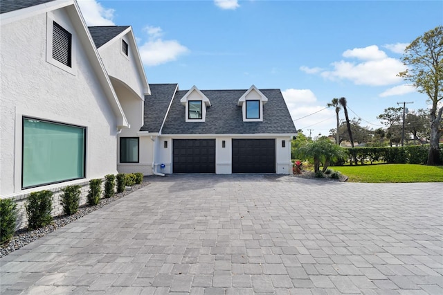 exterior space featuring a garage and a front yard