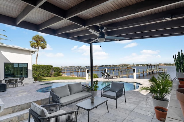 view of patio featuring a water view, ceiling fan, and an outdoor living space