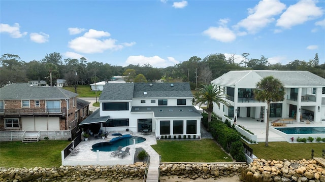 rear view of house with a lawn and a patio area