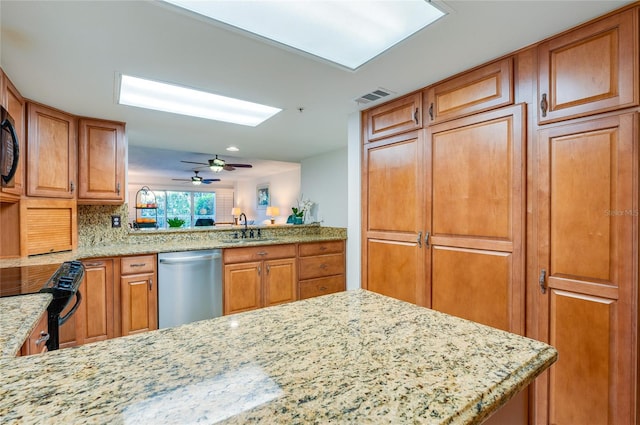 kitchen with light stone countertops, sink, stainless steel dishwasher, and black range with electric cooktop