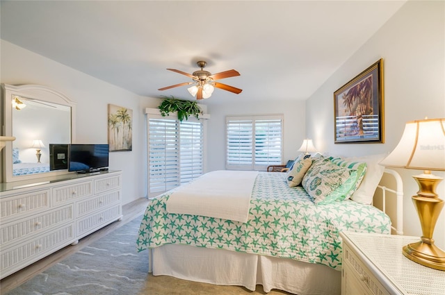 bedroom featuring hardwood / wood-style flooring and ceiling fan