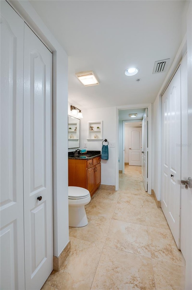 bathroom featuring vanity and toilet