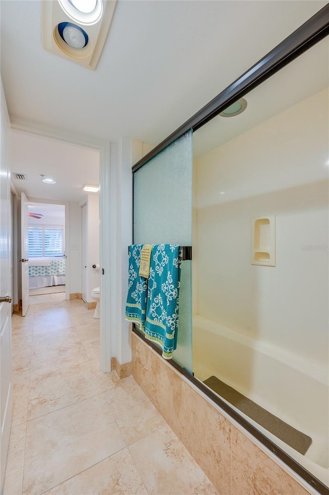 bathroom featuring toilet and an enclosed shower